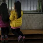 Children Watch As Voters Cast Their Ballots At A Polling Station During General Elections In Taipei