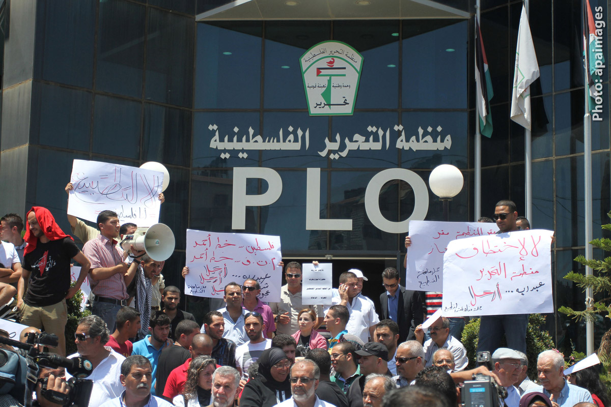 palestinians demonstrating in front of the palestine liberation organization (plo) offices